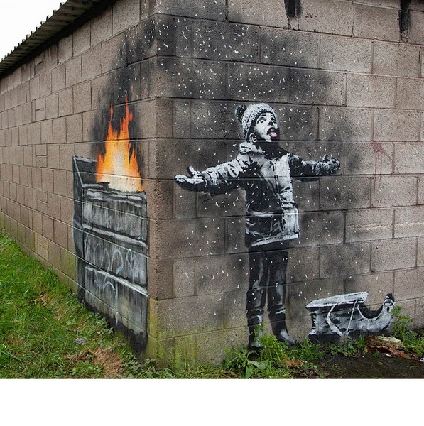 A mural depicting a child playing in the snow on a garage wall in the industrial town of Port Talbot, Wales (2018).Photo: banksy.co.uk