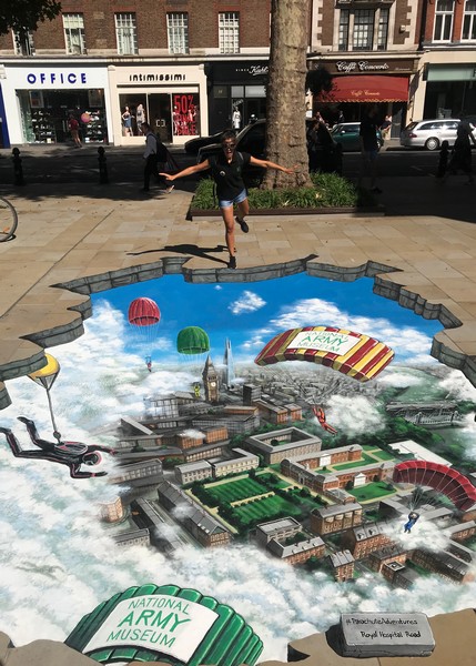 Three-dimensional pavement artwork by Joe & Max in London, commissioned by the National Army Museum. Visitors interact with the illusion. Photo: 3djoeandmax.com.