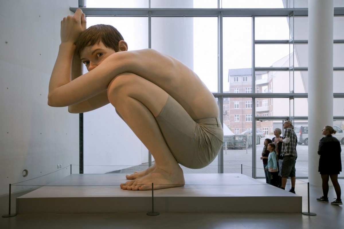 “Boy,” a five-meter-tall hyperrealistic sculpture by artist Ron Mueck, at the ARoS Aarhus Art Museum in Denmark. Photo: Shutterstock.