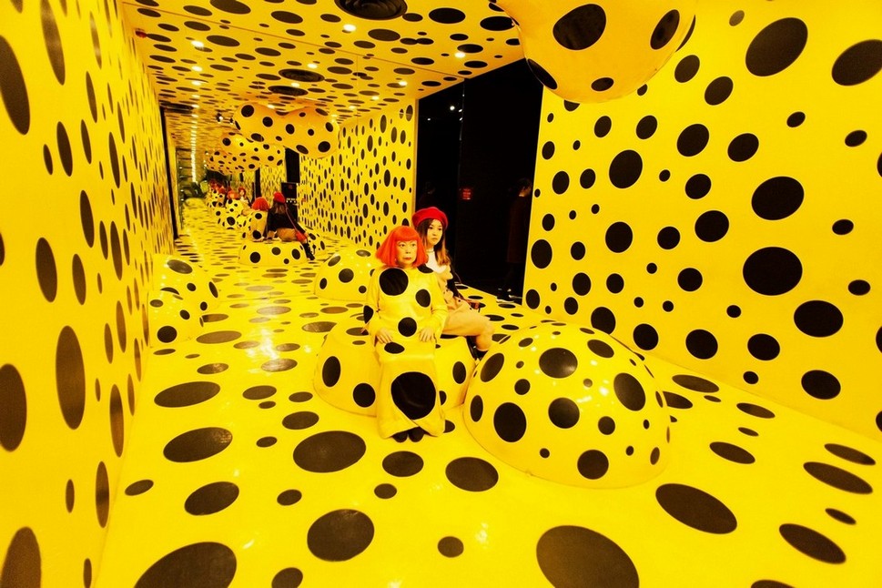 Japanese artist Yayoi Kusama appears inside one of her immersive installations filled with endless dots — the visual motif that has become her artistic signature. Photo: Shutterstock