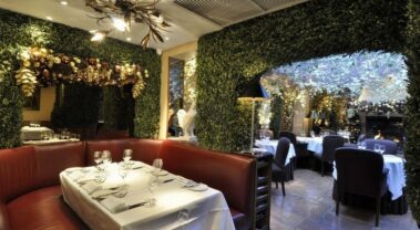 The restaurant’s intimate dining spaces are separated by lush greenery. Photography: Carol Sachs